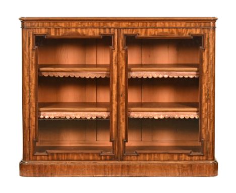 A Victorian mahogany low bookcase, with moulded edge and rounded corners with pair of glazed doors with geometric mouldings o