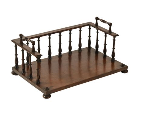 A mid 19th century mahogany book trough, with turned spindle supports and handles. Height 17 cm, width 35.5 cm, depth 23 cm (