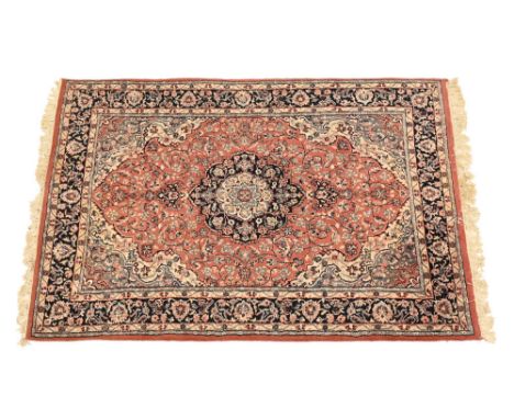A Persian rug, with peach and blue ground and floral decoration with tassels to either end.  Length excluding tassels 200 x 1