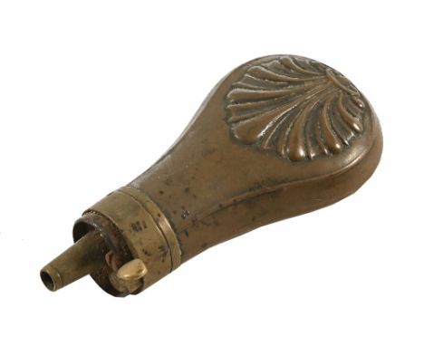 A copper bodied pistol powder flask, with shell decorated body. Length 9 cm.