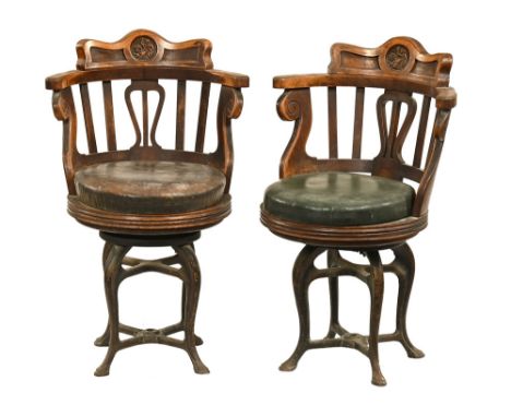 A pair of late 19th/early 20th century Brittania ships chairs, with oak backs and upholstered seats and cast iron bases. Heig
