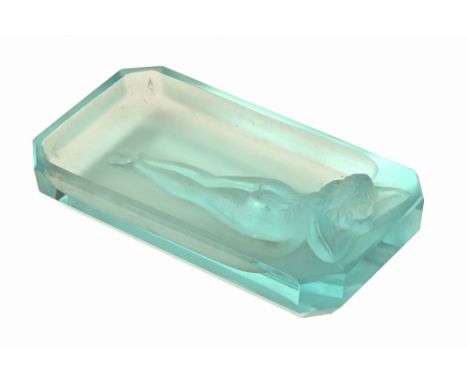 An Art Deco turquoise glass pin tray/paperweight, depicting a nude female figure. Length 12 cm.This lot is generally in quite