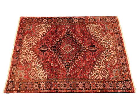A vintage Persian rug, with red ground and geometric repeating design. 336 x 272 cm (see illustration).