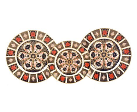 A pair of Royal Crown Derby Imari pattern 1128, dinner plates 27 cm printed marks in red, together with 21.5 cm plate.