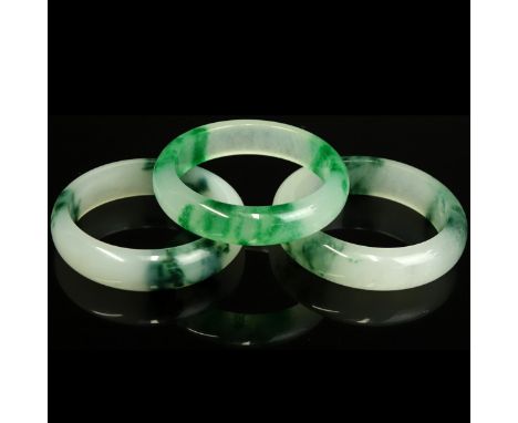 Three (3) Chinese Jade Bangle Bracelets. White with apple green splashes. Interior measures 2-3/8' Dia. Domestic Shipping: $3