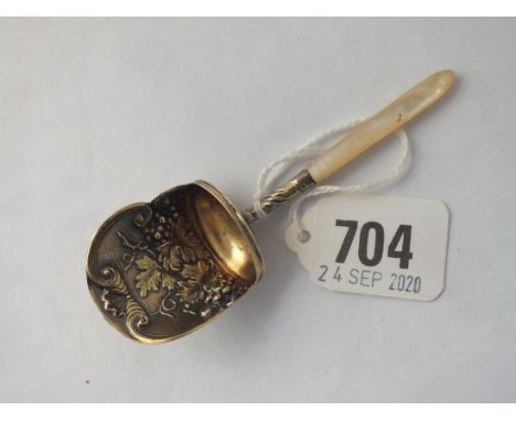 A George III caddy spoon with gilt bowl embossed with vine motifs. M.o.p. handle - B'ham 1913 by SP