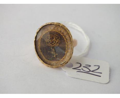 AN ANTIQUE GOLD JACOBEAN MOURNING JEWEL MOUNTED AS A RING, THE DESIGN SHOWS A MONOGRAM IN FINE GOLD WIRE WITH A DOVE ABOVE &a