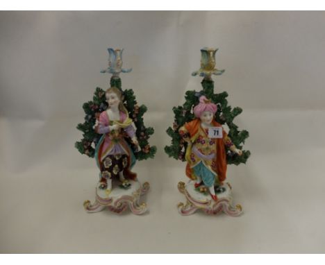 a pair of coloured enamel, hand painted porcelain figural candlesticks a/f