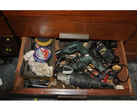 THE CONTENTS OF A DRAWER FULL OF POWER TOOLS, including a Bosch electric drill, a Black and Decker Professional 4'' angle gri