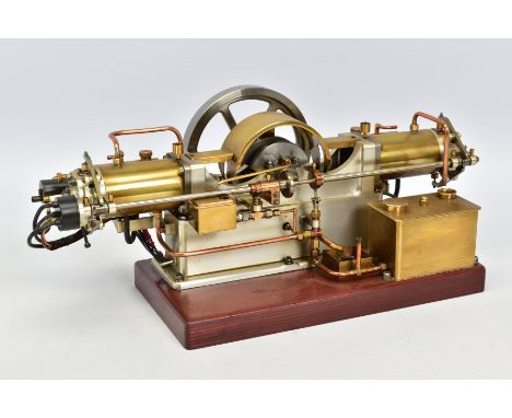 A HANDBUILT MODEL HORIZONTAL TWIN CYLINDER STATIONARY ENGINE, cylinder flanking central flywheel (diameter approximately 12.5