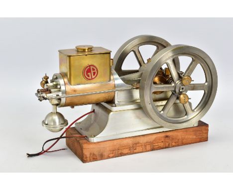 A HANDBUILT MODEL HORIZONTAL SINGLE CYLINDER STATIONARY ENGINE, powering twin flywheels (diameter approximately 15cm), not te