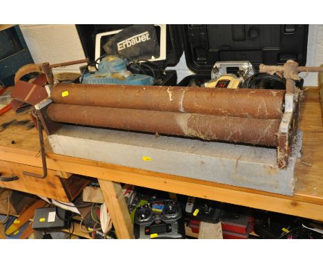 A HANDMADE MANUAL SHEET METAL ROLLER, with three 66cm long (missing thickness stop plates)