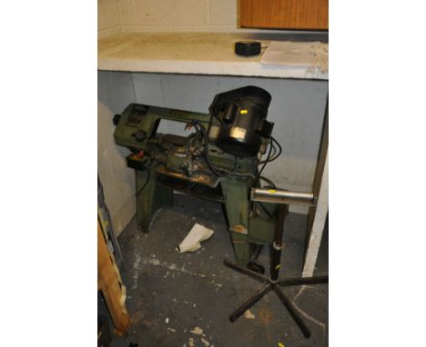 A WARCO 4 1/2'' METAL CUTTING BAND SAW, on stand with a homemade roller stand (2)