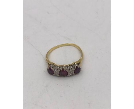 A ruby and diamond ring on a mount marked 18k