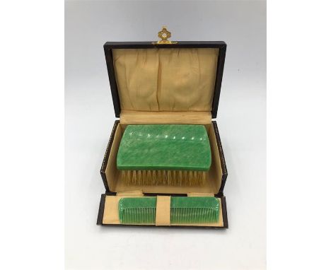 A Vintage Bakerlite brush and comb set in a box
