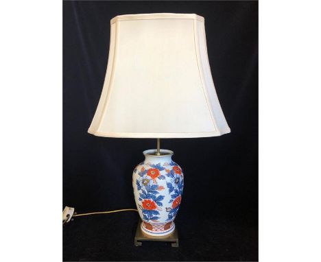 A Lamp base with Imari collars on a brass base and cream shade.