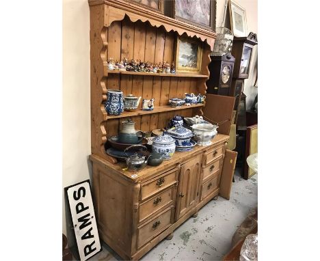 A Pine dresser with two shelves, six drawers, middle cupboard.