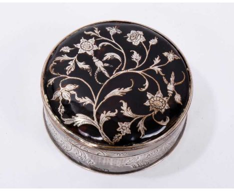Two antique snuff boxes, one with tortoishell and inlaid foliage with silver plated copper base, 62mm diameter, the other box