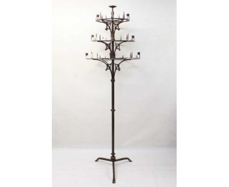 Unusual late 19th/early 20th century floor standing wrought iron candle stand, with three graduated pricket tiers on scrolled