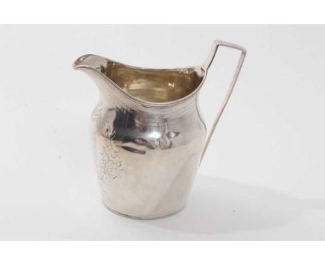 George III silver cream jug of helmet form, with strap handle, engraved foliate decoration and vacant cartouche (London1800) 