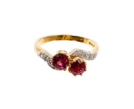 Ruby two-stone ring with two round mixed cut rubies in cross-over claw setting with diamond set shoulders on 18ct gold shank.