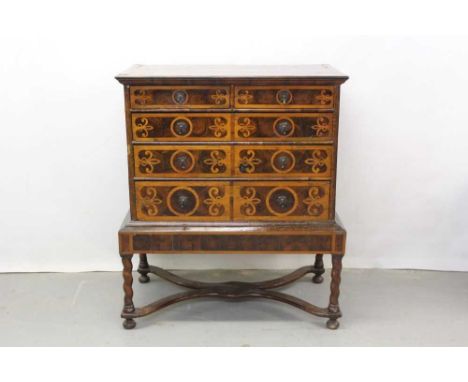 Fine William and Mary laburnum oyster veneered chest on later stand with two short and three long drawers with fleur de lys m