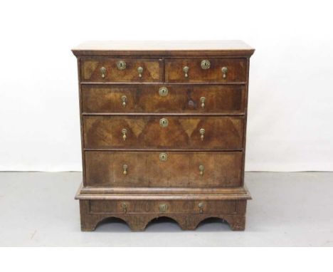Early 18th century country walnut and grained pine chest on stand with an arrangement of two short and three long graduated d