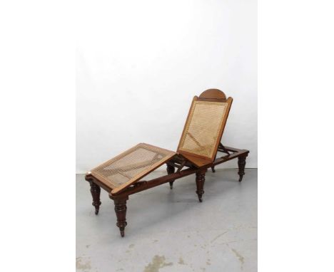 Late Victorian officers' folding mahogany framed campaign bed with caned base and adjustable back on removable turned legs on