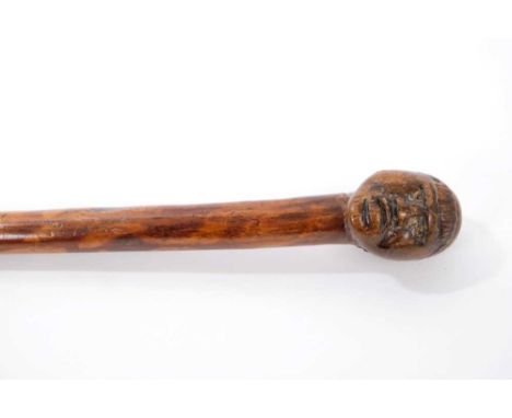 Good early carved hardwood and bamboo walking stick, the wooden terminal carved with figurehead, on mottled tapering shaft, 8
