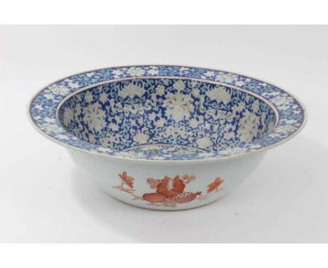 Large antique Chinese porcelain bowl, circa 1900, decorated with bats, fish and foliate patterns on a dark blue ground, 41cm 