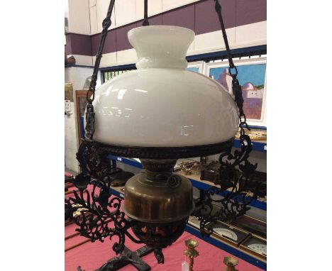 Art Nouveau hanging ceiling light, the brass reservoir in black painted metal basket and milk glass shade, with fitting for p