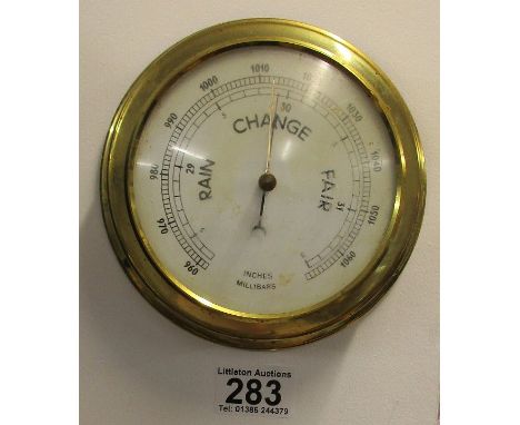 Small circular brass barometer