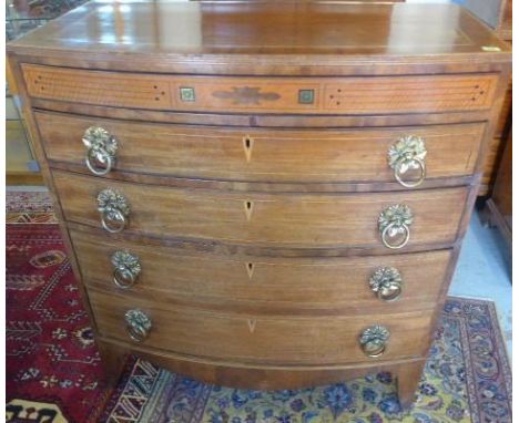 A good Regency mahogany bow fronted chest with an inlaid slim drawer above two graduating drawers and a double drawer standin