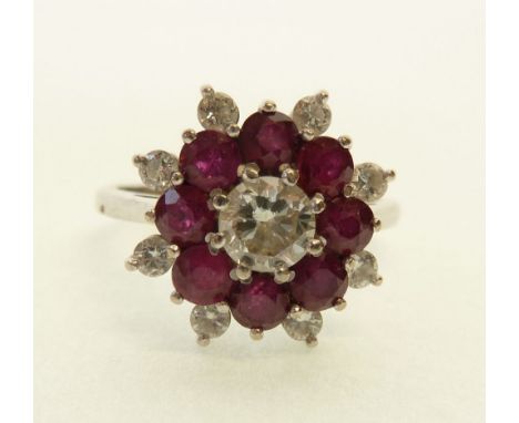 18CT WHITE GOLD, DIAMOND AND RUBY CLUSTER RING, central round brilliant cut diamond 0.40ct approx., with a surround of eight 