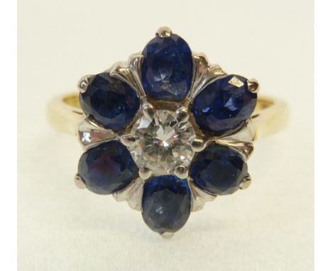 SINGLE STONE DIAMOND AND SAPPHIRE CLUSTER RING, central claw set brilliant cut diamond 0.22ct approx., with a white metal set