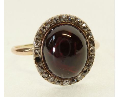 ANTIQUE GARNET CABOCHON AND DIAMOND SET RING, the bezel set oval garnet 11.1mm x 9.1mm approx., in closed back setting, with 