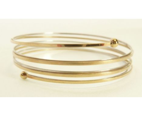 STAMPED 9CT WHITE AND YELLOW GOLD COIL BANGLE, formed of white and yellow gold coil bands with ball terminals, 6g