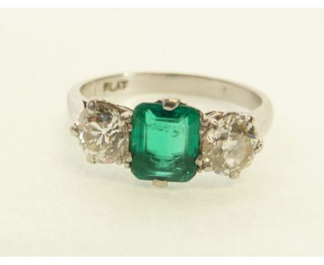 STAMPED PLATINUM EMERALD AND TWO STONE DIAMOND RING, central claw set synthetic emerald flanked by two old cut diamonds, each