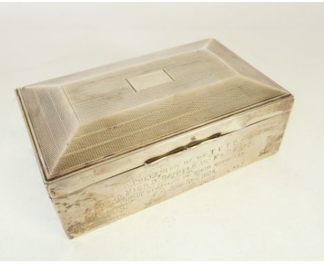 ENGINE TURNED SILVER CASED TABLE CIGARETTE BOX, with four line presentation inscription, Birmingham 1927, 1 ¾" x 5 ¾" x 3 ½" 