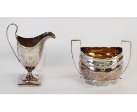 GEORGE III SILVER SUGAR BASIN, boat shape with angular handles and bright cut decoration, London 1800 AND A NEAR MATCHED GEOR