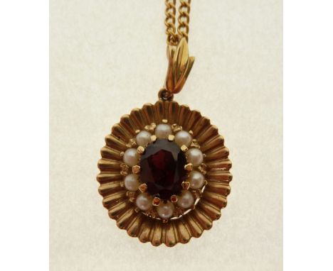 STAMPED 9CT GOLD GARNET AND SEED PEARL PENDANT, claw set oval cut garnet, with a cluster surround of ten seed pearls, in 9ct 