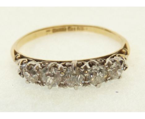 FIVE STONE DIAMOND RING, claw set with five graduated old cut diamonds, 0.10ct approx. and smaller, pierced scroll gallery an