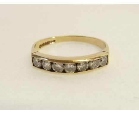 9CT GOLD SEVEN STONE DIAMOND HALF HOOP RING, each diamond 0.05ct approx., channel set to the half hoop band, Birmingham 1989,