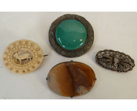 AN ARTS AND CRAFTS GREEN GLAZED CERAMIC BROOCH, WITH PEWTER FRAME, 2" (5cm) diameter, AN AGATE BROOCH, A CARVED BONE BROOCH A