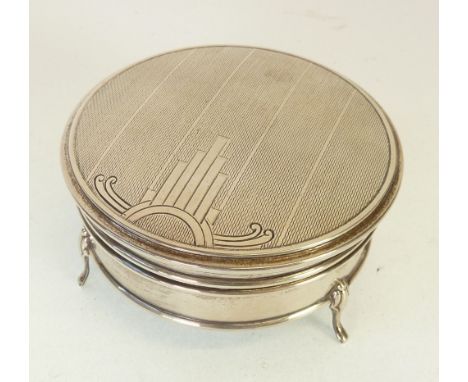 ART DECO ENGINE TURNED SILVER CIRCULAR JEWELLERY BOX, by WALKER & HALL, the hinged lid with art deco motif, raised on three s