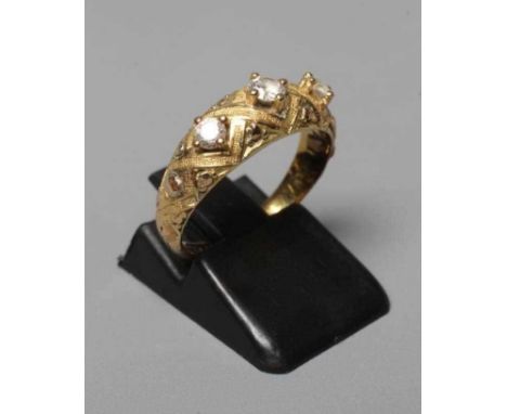A MID VICTORIAN THREE STONE DIAMOND RING, the old cut stones point set to a lattice chased mount and shoulders on plain 18ct 