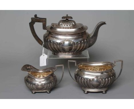 AN EDWARDIAN SILVER MATCHED THREE PIECE TEA SERVICE by John Round &amp; Son Ltd., Sheffield 1903/1904 (teapot), of semi-flute