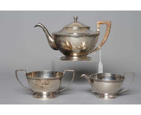 A THREE PIECE SILVER TEA SERVICE by D &amp; J Wellby Ltd., London 1925, of plain shallow rounded cylindrical form with applie