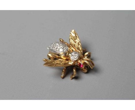 AN 18CT GOLD NOVELTY INSECT BROOCH set with two facet cut ruby eyes and with pave set diamonds to the body and thorax, London