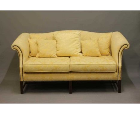 A GEORGIAN STYLE HUMP BACKED SOFA, 20th century, upholstered in yellow floral silk damask, scrolled arms, loose cushions, on 